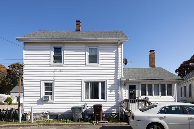 rear view of house featuring cooling unit