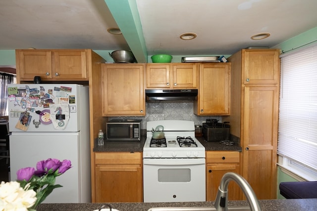 kitchen featuring backsplash and white appliances