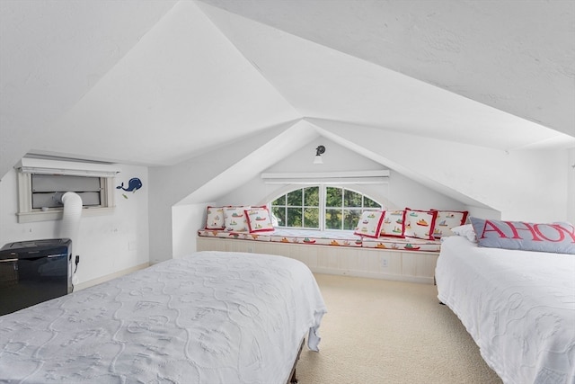 bedroom featuring lofted ceiling and carpet