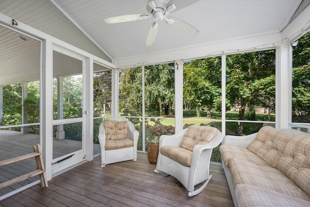 sunroom with ceiling fan and vaulted ceiling