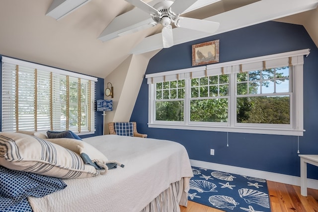 bedroom featuring ceiling fan, vaulted ceiling, and wood-type flooring