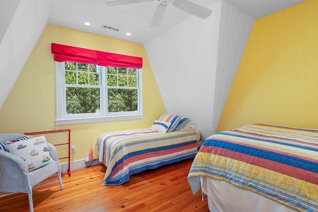 bedroom featuring wood-type flooring, vaulted ceiling, and ceiling fan