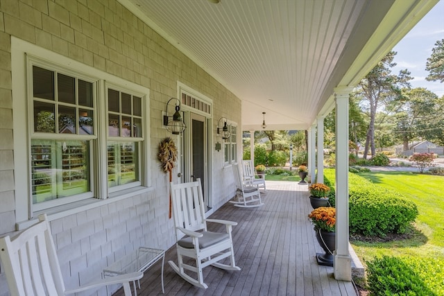 wooden deck with a yard and a porch