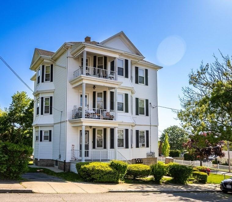 view of front of house with covered porch and a balcony