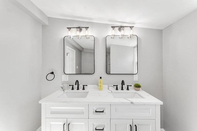 full bath with a sink and double vanity