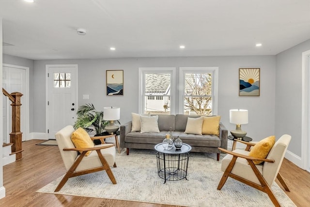 living area featuring stairway, recessed lighting, and light wood-type flooring