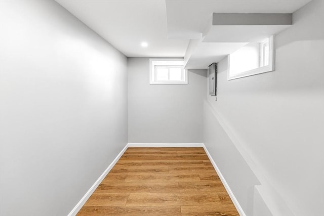 basement featuring wood finished floors and baseboards