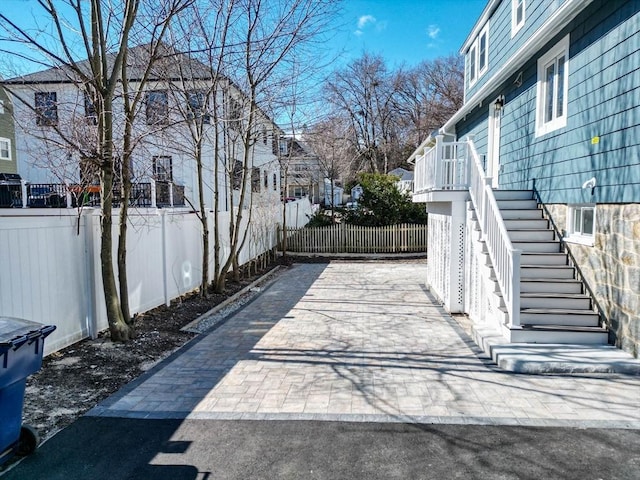 view of patio / terrace featuring stairs and fence