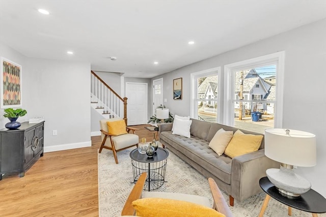 living room with stairway, recessed lighting, light wood-type flooring, and baseboards