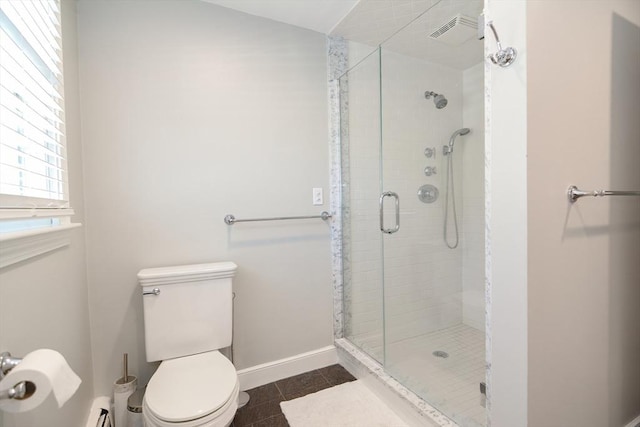 full bath featuring baseboards, a stall shower, and toilet