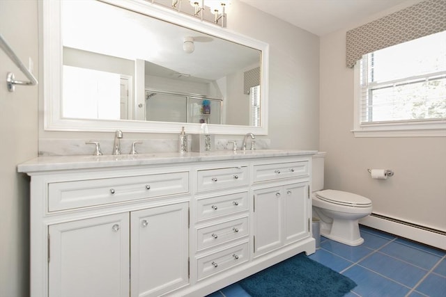 bathroom featuring double vanity, toilet, a shower stall, and a sink