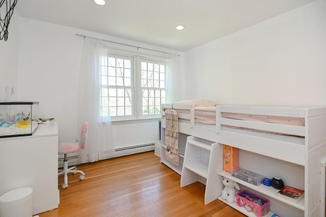 bedroom with recessed lighting, a baseboard heating unit, and light wood finished floors