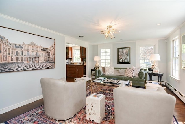living room with crown molding, wood finished floors, baseboards, a baseboard heating unit, and a chandelier
