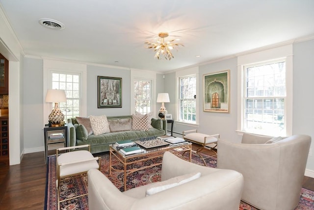 living area with plenty of natural light, ornamental molding, dark wood-type flooring, and visible vents