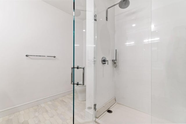 full bathroom featuring a shower stall and baseboards