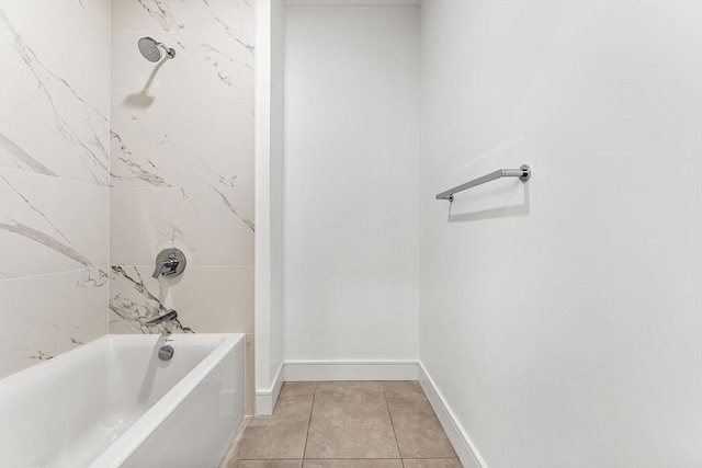 bathroom with baseboards, washtub / shower combination, and tile patterned floors