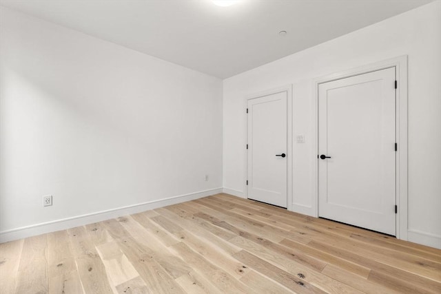 unfurnished bedroom with light wood-style floors and baseboards