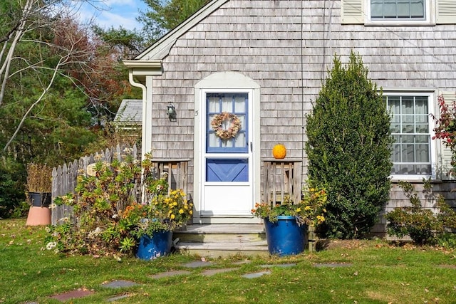 entrance to property featuring a lawn