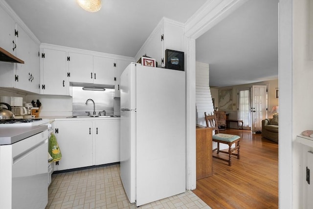 kitchen featuring white appliances, crown molding, sink, white cabinets, and light hardwood / wood-style floors