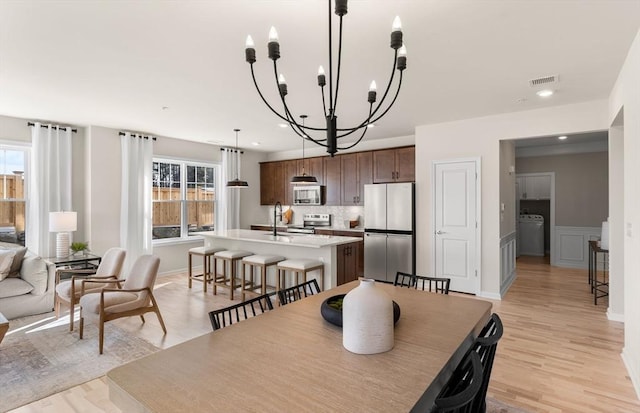 2 Codman Way Unit 301, Westborough, MA 01581 - dining space featuring washer / clothes dryer, a chandelier, healthy amount of natural light, light wood finished floors, and recessed lighting