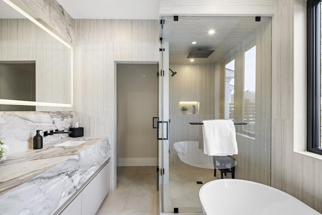 full bath with a freestanding tub, vanity, a shower stall, tile patterned floors, and tasteful backsplash