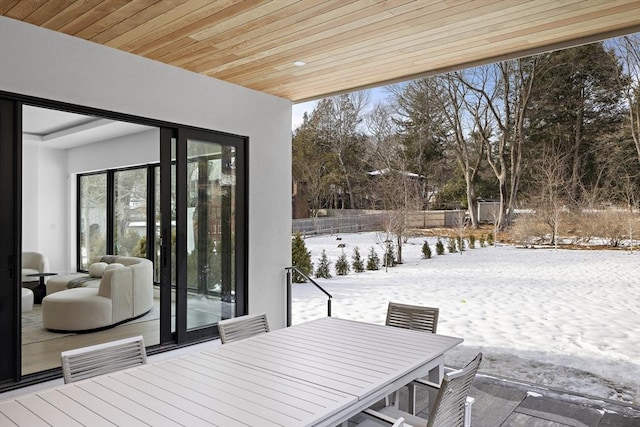 snow covered deck featuring outdoor dining space