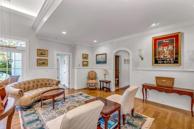 living room with crown molding and light hardwood / wood-style flooring