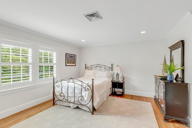 bedroom with hardwood / wood-style flooring and ornamental molding