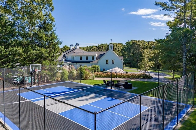 view of sport court featuring tennis court