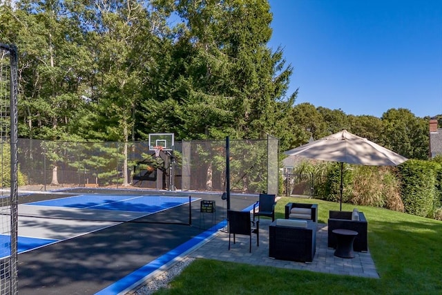 view of basketball court featuring tennis court and a lawn