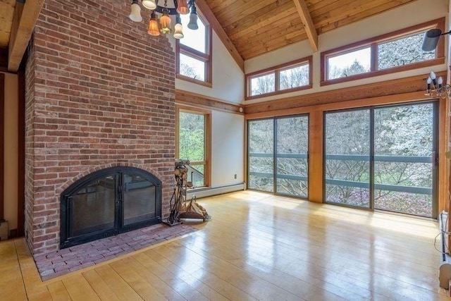 20 Lawton Rd, Leverett, MA 01054 - unfurnished living room with a brick fireplace, a chandelier, wood ceiling, high vaulted ceiling, and hardwood / wood-style flooring