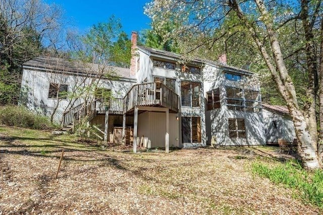 20 Lawton Rd, Leverett, MA 01054 - rear view of property featuring a chimney, a wooden deck, a sunroom, and stairway