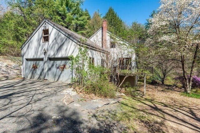 20 Lawton Rd, Leverett, MA 01054 - view of home's exterior featuring a chimney, a garage, and a deck
