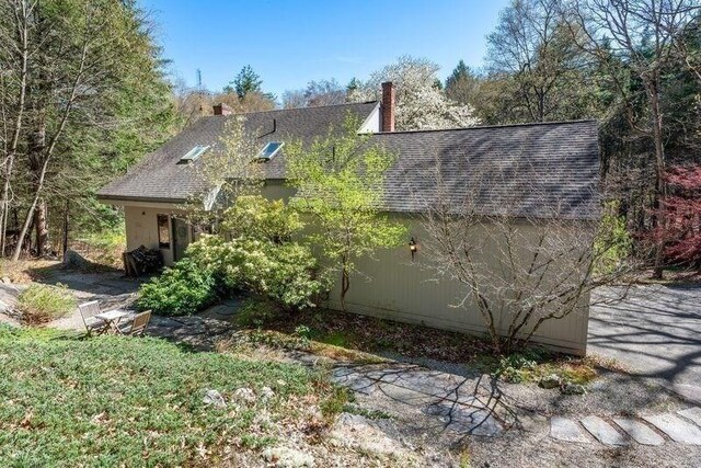 20 Lawton Rd, Leverett, MA 01054 - view of property exterior with a shingled roof and a chimney