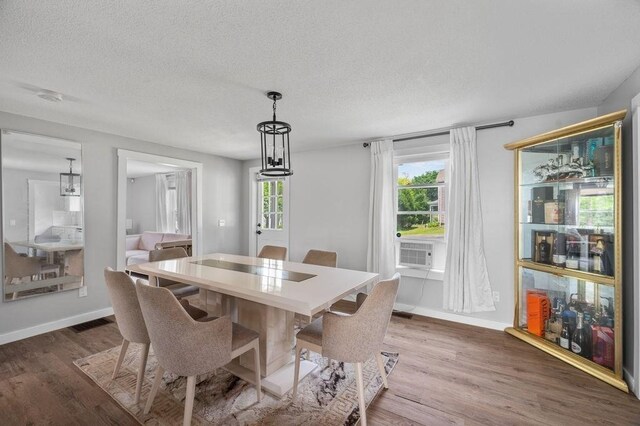 4002 Church St, Palmer, MA 01069 - dining space with wood finished floors, a textured ceiling, and cooling unit