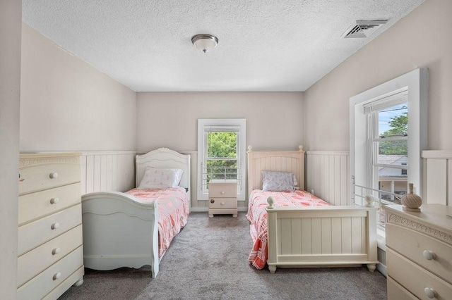 4002 Church St, Palmer, MA 01069 - carpeted bedroom with a wainscoted wall and a textured ceiling