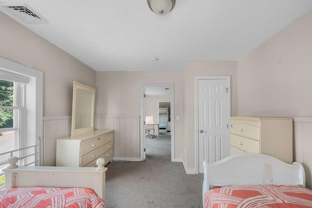 4002 Church St, Palmer, MA 01069 - carpeted bedroom featuring a textured ceiling and wainscoting