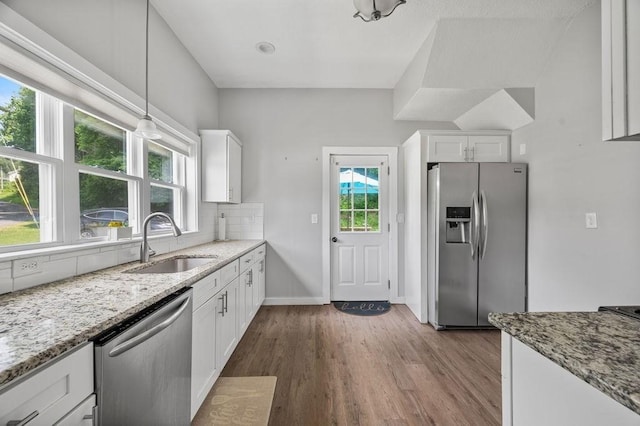 4002 Church St, Palmer, MA 01069 - kitchen featuring appliances with stainless steel finishes, dark wood-style floors, white cabinetry, tasteful backsplash, and light stone counters