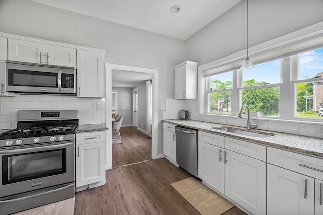 4002 Church St, Palmer, MA 01069 - kitchen with appliances with stainless steel finishes, white cabinets, tasteful backsplash, dark wood finished floors, and light stone countertops