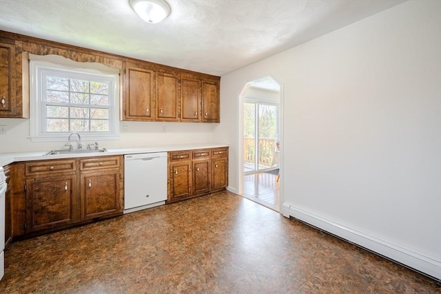 kitchen with a sink, a baseboard radiator, plenty of natural light, and dishwasher