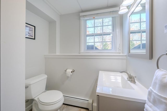 bathroom featuring toilet, baseboard heating, and vanity