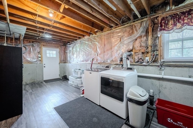 basement with separate washer and dryer and wood finished floors