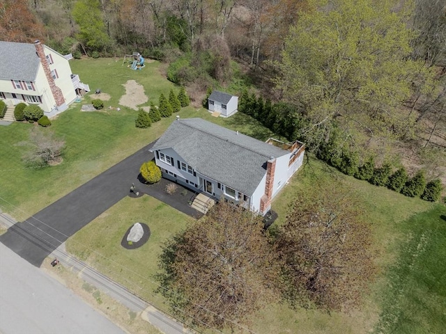 birds eye view of property with a forest view