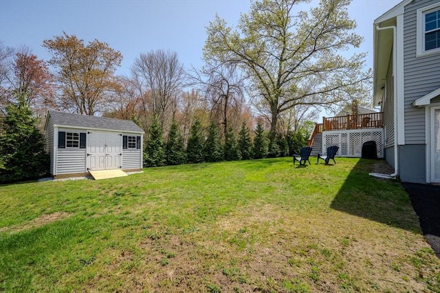 view of yard with an outbuilding and a deck