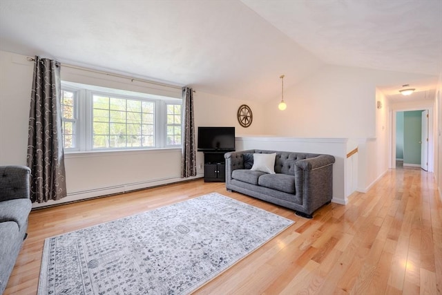 living area with a baseboard heating unit, vaulted ceiling, and light wood finished floors