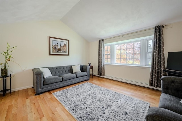 living room featuring a baseboard radiator, vaulted ceiling, and light wood-style flooring