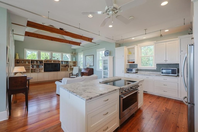 1794 Drift Unit E, Westport, MA 02790 - kitchen with stainless steel appliances, open floor plan, a kitchen island, white cabinetry, and recessed lighting