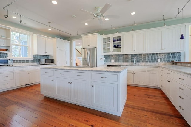 1794 Drift Unit E, Westport, MA 02790 - kitchen featuring stainless steel appliances, white cabinets, tasteful backsplash, ceiling fan, and recessed lighting