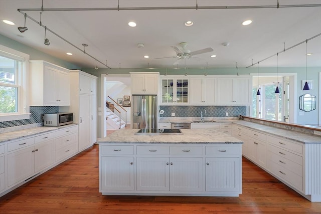 1794 Drift Unit E, Westport, MA 02790 - kitchen with appliances with stainless steel finishes, a peninsula, plenty of natural light, tasteful backsplash, and recessed lighting