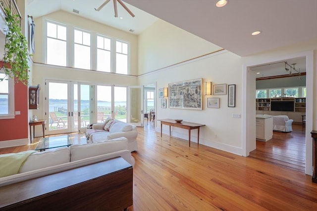 1794 Drift Unit E, Westport, MA 02790 - living area featuring light wood finished floors, french doors, ceiling fan, recessed lighting, and a high ceiling